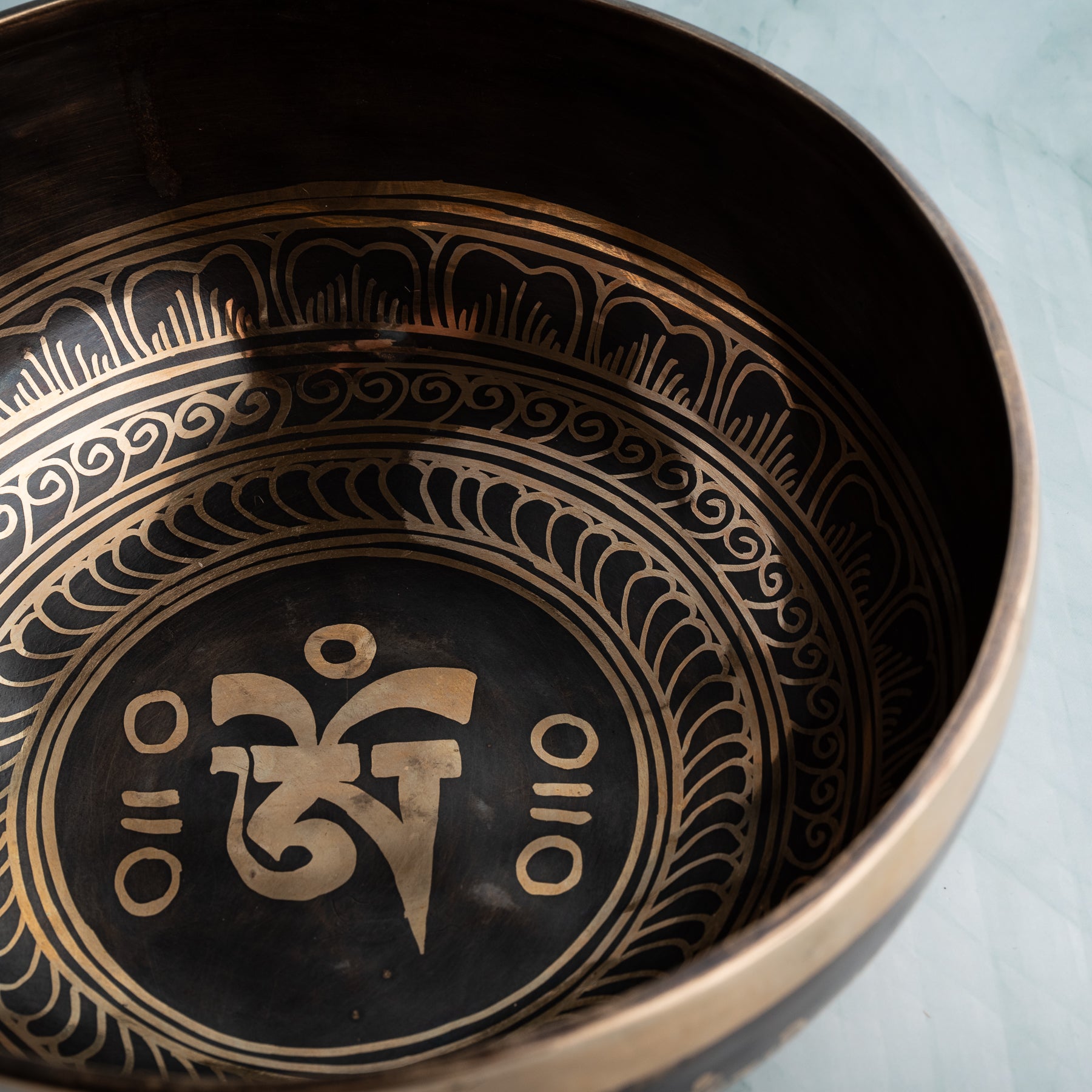 Detail shot a singing bowl with an inscription inside