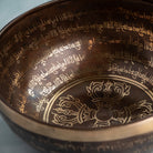 Close up of singing bowl with inscriptions inside it