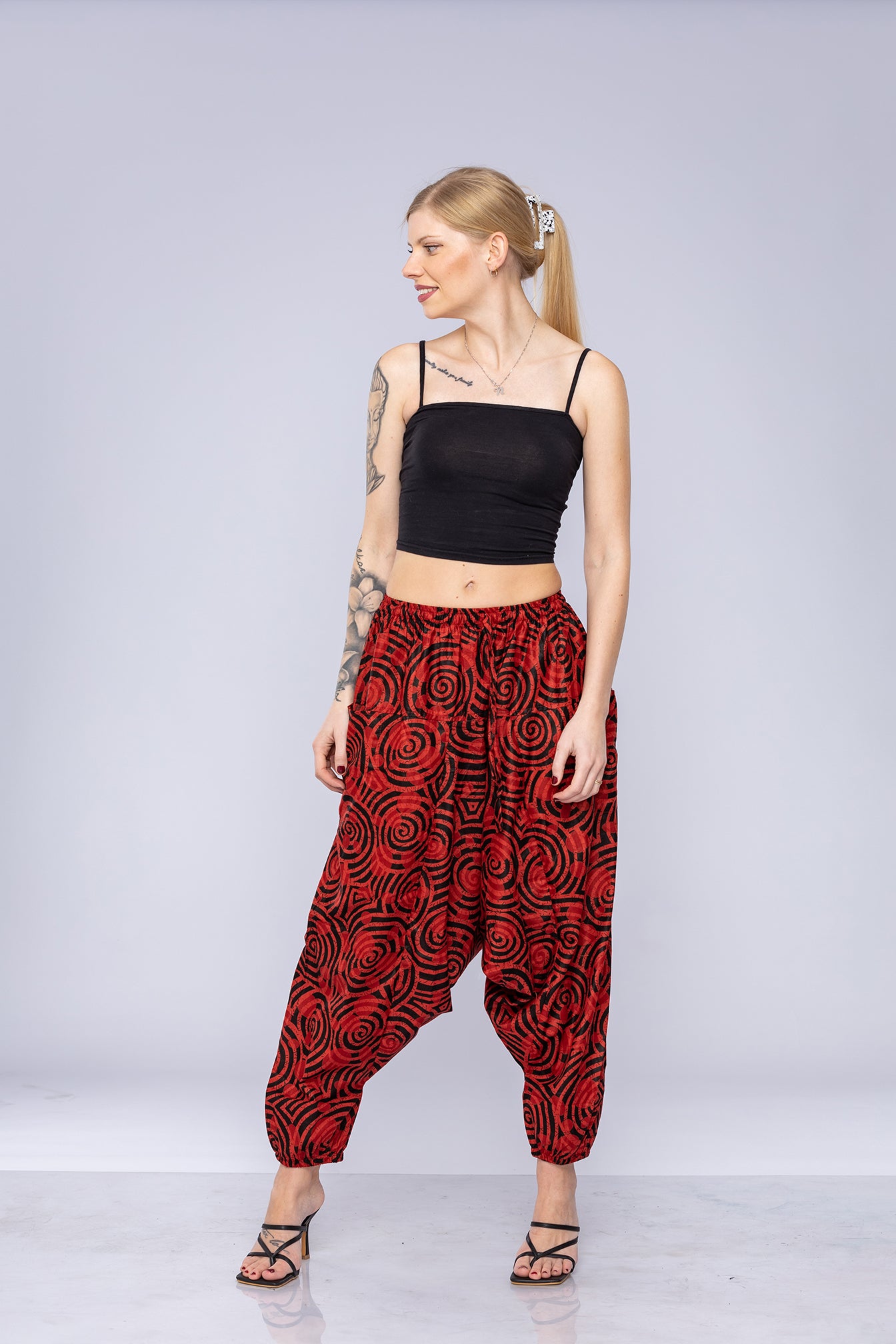 Woman wearing red Ogee harem pants