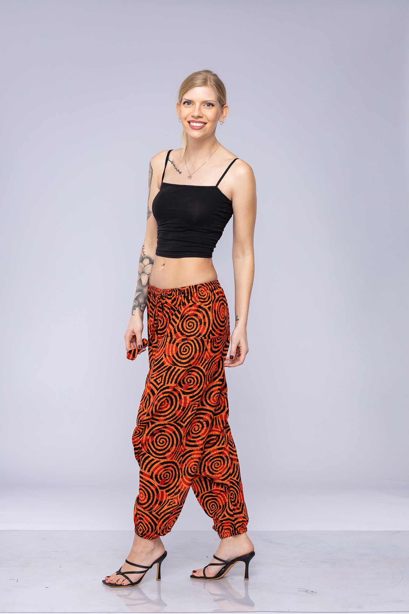 Woman wearing orange Ogee harem pants