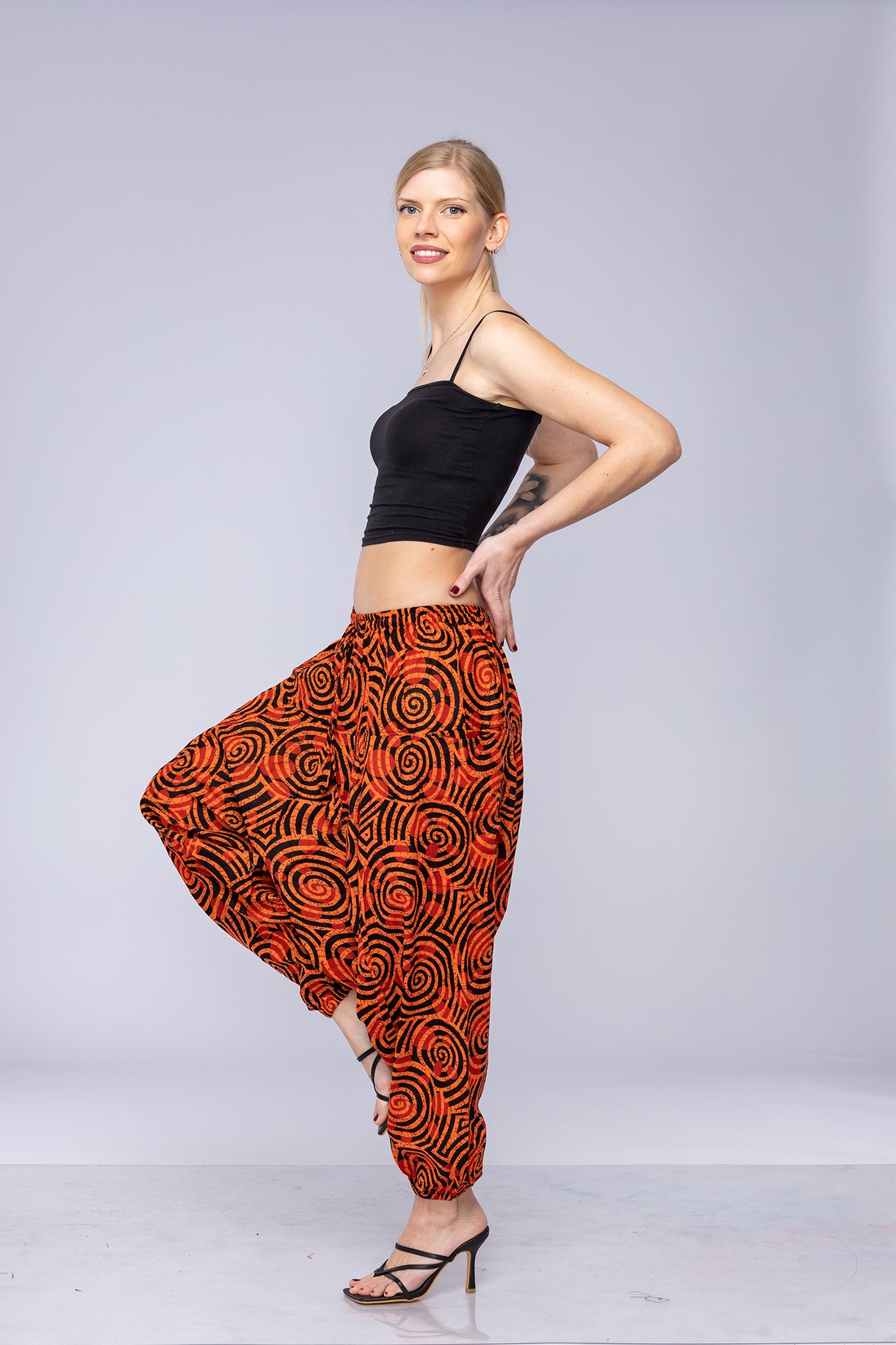 Woman wearing orange Ogee harem pants