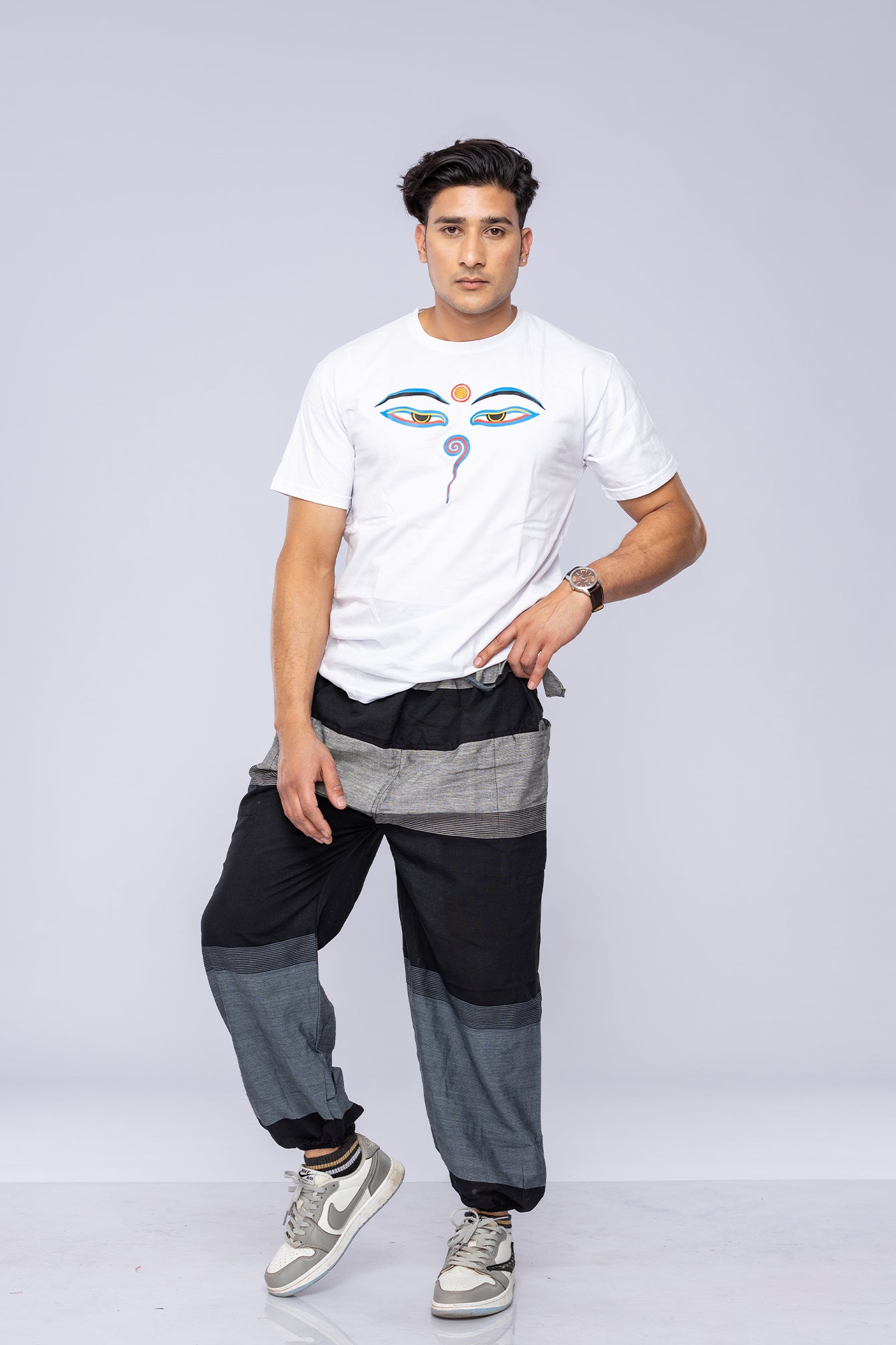 Man modelling an Eyes of Buddha T-shirt and harem pants